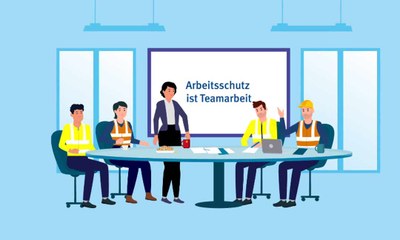 Eine Gruppe von Beschäftigten sitzt um einen Besprechungstisch
