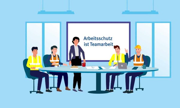 Eine Gruppe von Beschäftigten sitzt um einen Besprechungstisch